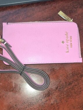 kate spade pink leather phone wristlet with gold logo